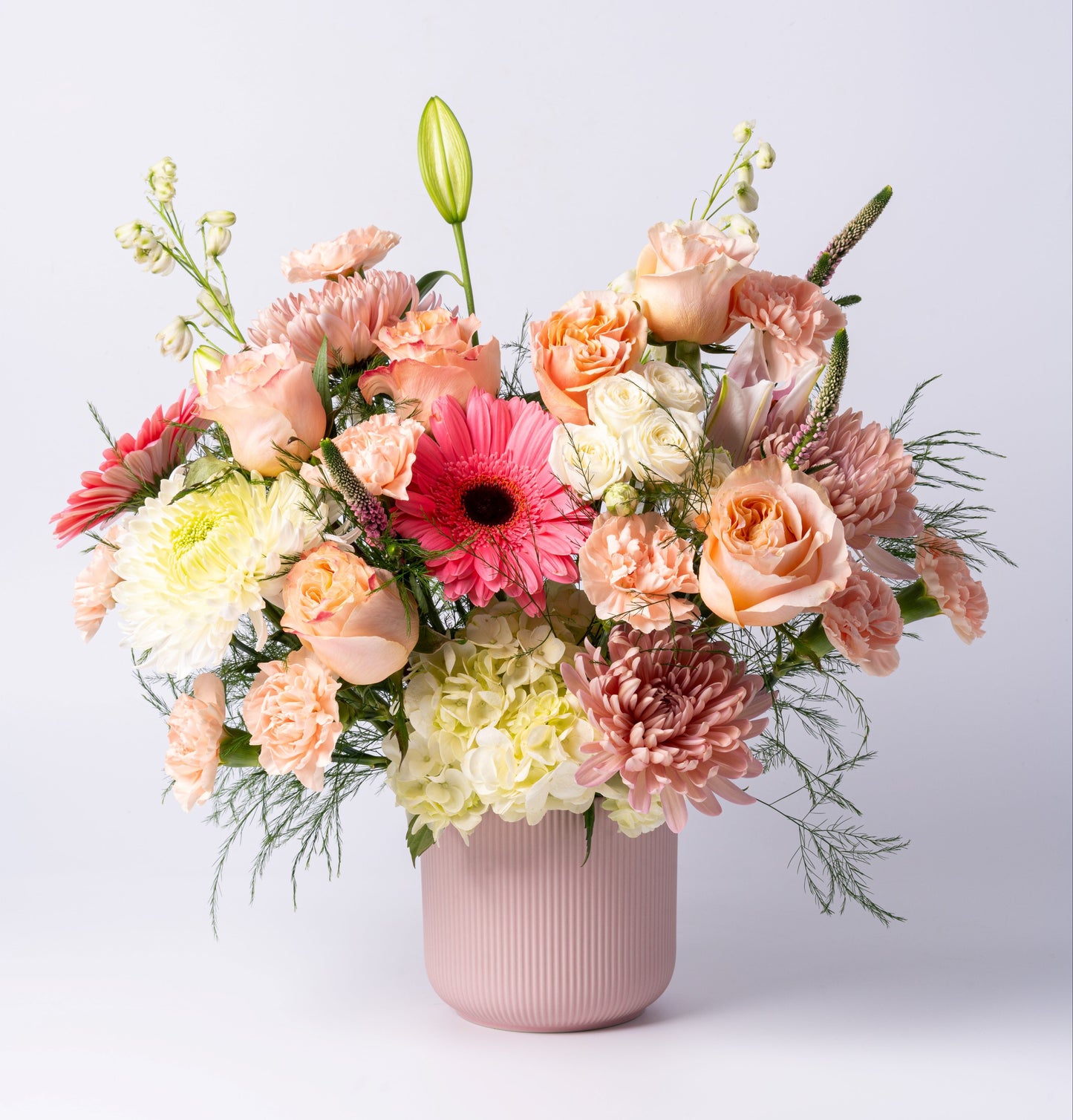 Romantic pastel vase arrangement with peach roses, gerberas, hydrangea, and chrysanthemums. Perfect for birthdays & celebrations. Toronto same-day delivery