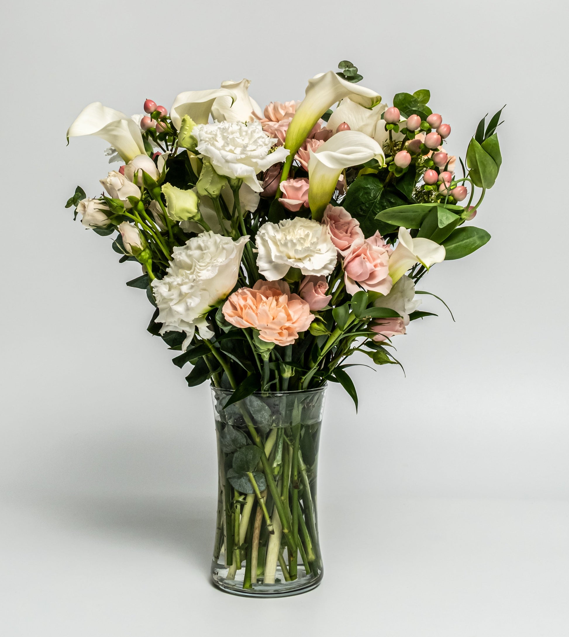 Elegant white and blush floral vase arrangement with calla lilies, roses, and carnations. Handcrafted daily by Rainbow Floral in Toronto. Same-day delivery available.