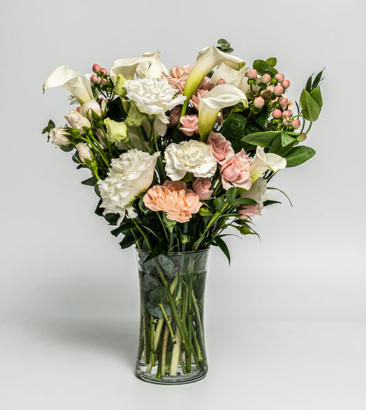 Elegant white and blush floral vase arrangement with calla lilies, roses, and carnations. Handcrafted daily by Rainbow Floral in Toronto. Same-day delivery available.