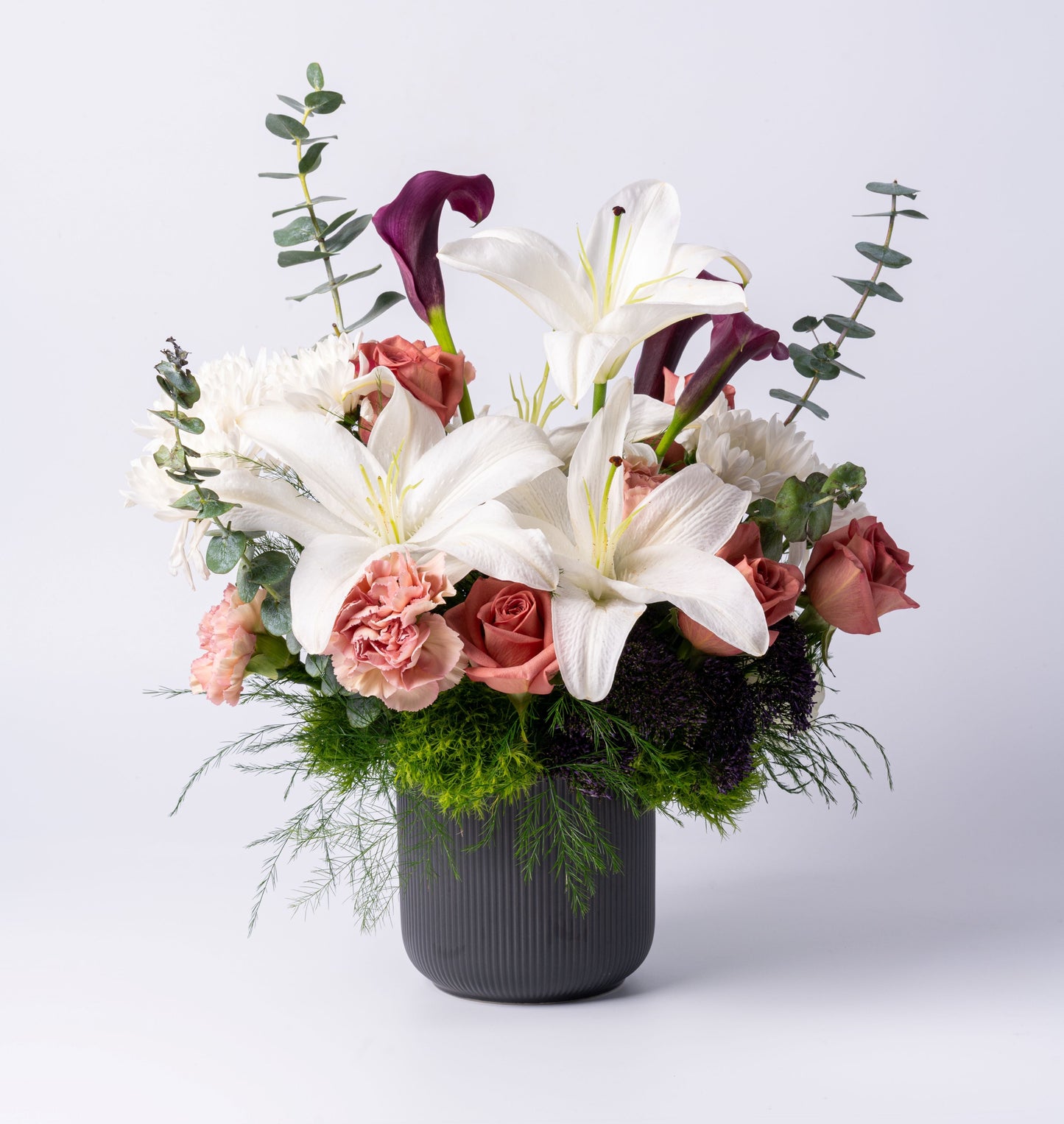 Romantic vase arrangement with lilies, calla lilies, blush roses, and deep tones. A luxury gift for any occasion. Same-day Toronto flower delivery.