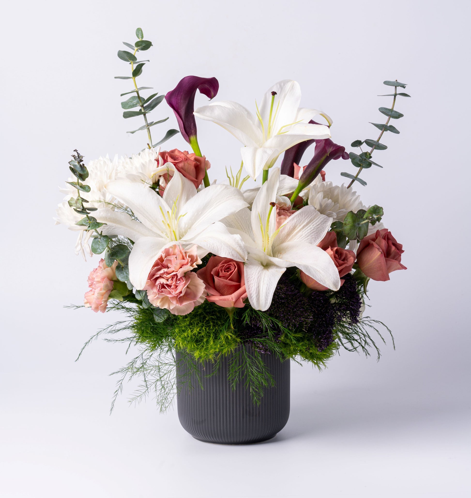 Romantic vase arrangement with lilies, calla lilies, blush roses, and deep tones. A luxury gift for any occasion. Same-day Toronto flower delivery.