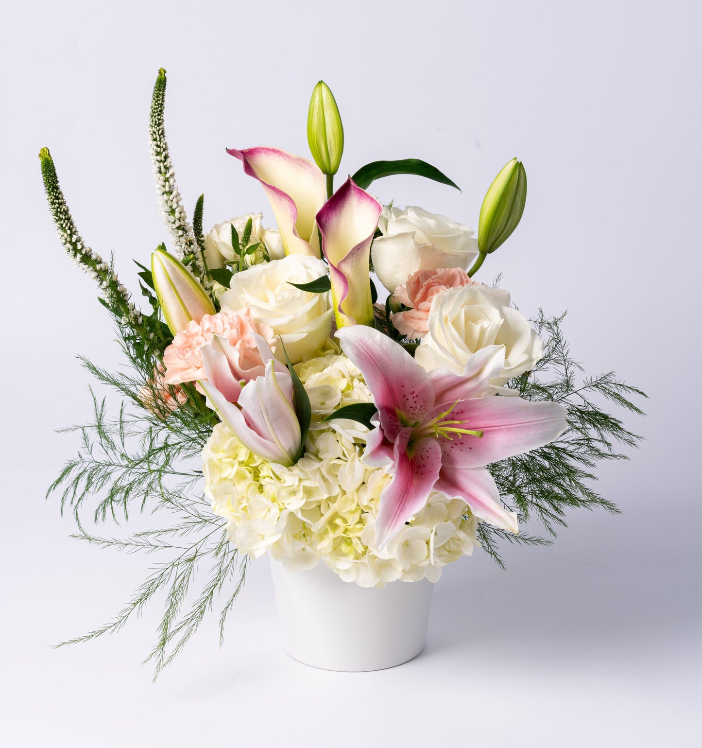Elegant pastel vase with stargazer lilies, calla lilies, white roses, and hydrangea. A soft, romantic gift. Same-day Toronto flower delivery