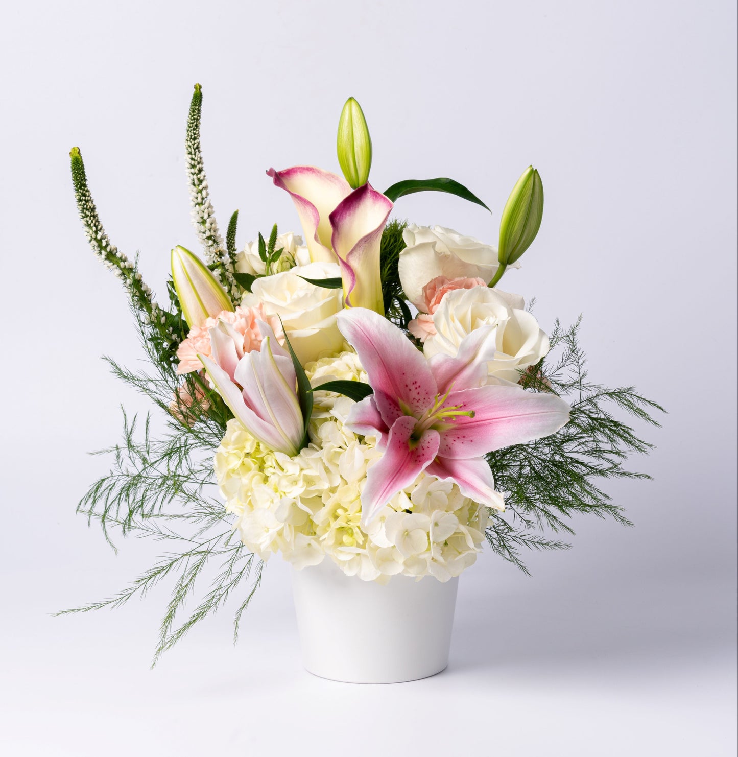 Elegant pastel vase with stargazer lilies, calla lilies, white roses, and hydrangea. A soft, romantic gift. Same-day Toronto flower delivery