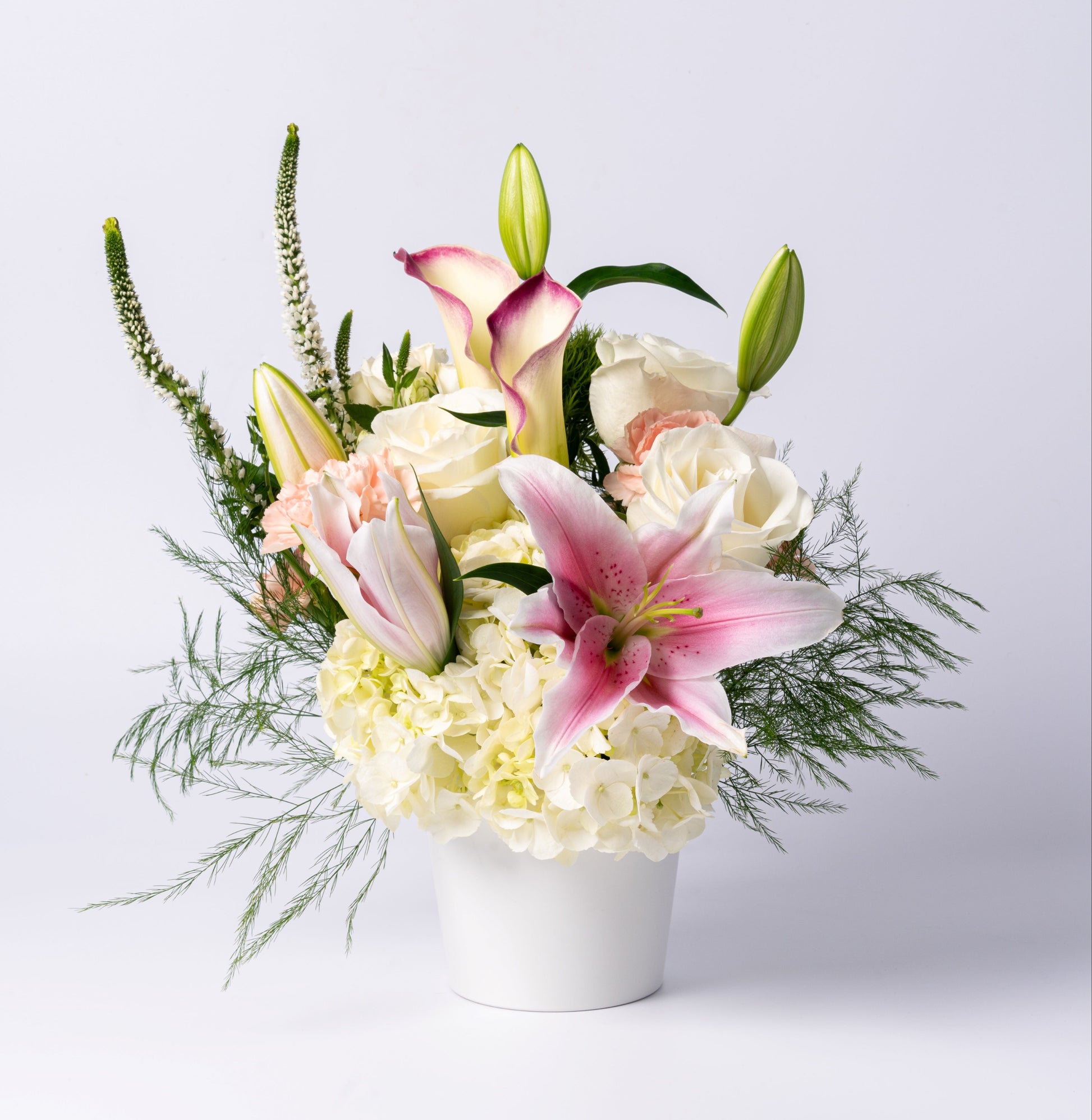 Elegant pastel vase with stargazer lilies, calla lilies, white roses, and hydrangea. A soft, romantic gift. Same-day Toronto flower delivery