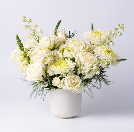 White vase arrangement with roses, hydrangea, chrysanthemums, and snapdragons in a modern ceramic pot – Rainbow Floral Toronto